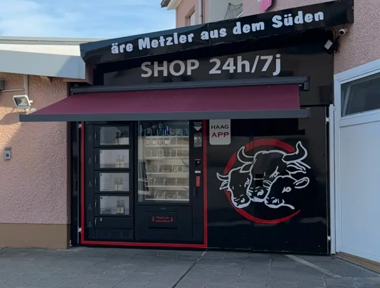 De Shop 24h/7j vu vir, mam Automat an dem Haag-Zeechen